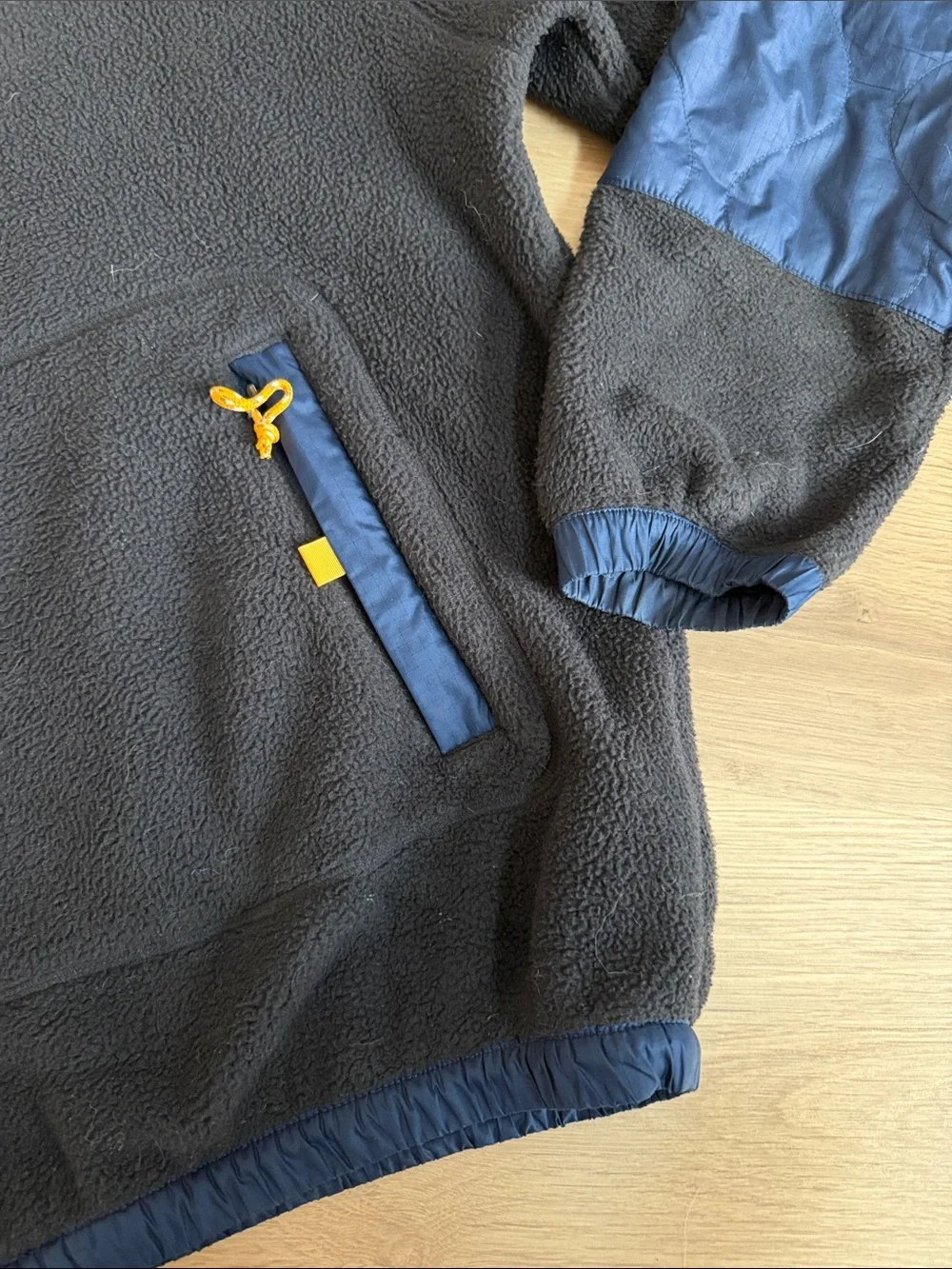 The North Face Black Fleece Hoodie with Blue Panels and Orange Accents